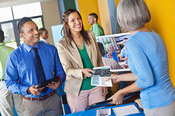 woman handing out corporate one pager