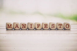 Manifesto word written on cube wooden blocks
